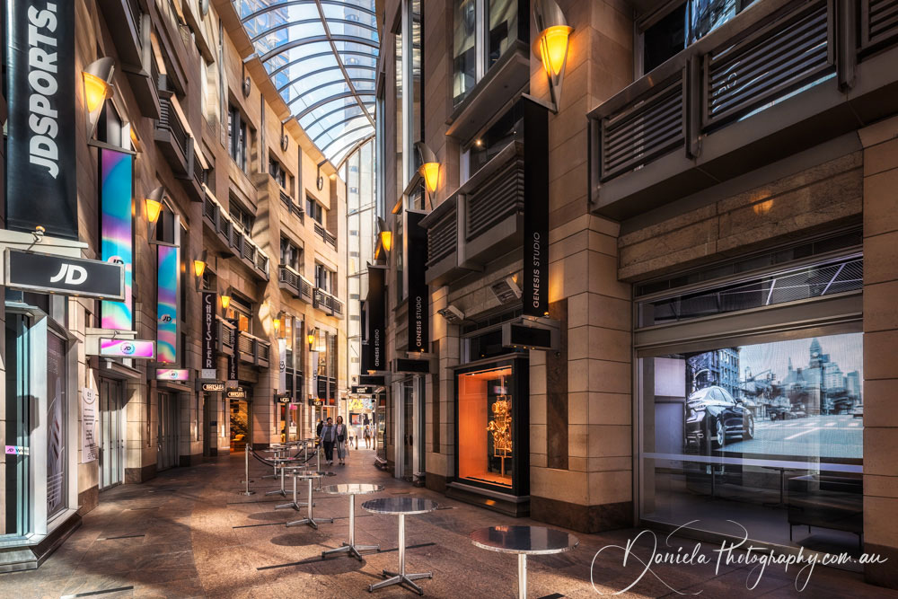 Curved passage arcade with numerous boutique retail shops and eateries in Sydney, Australia